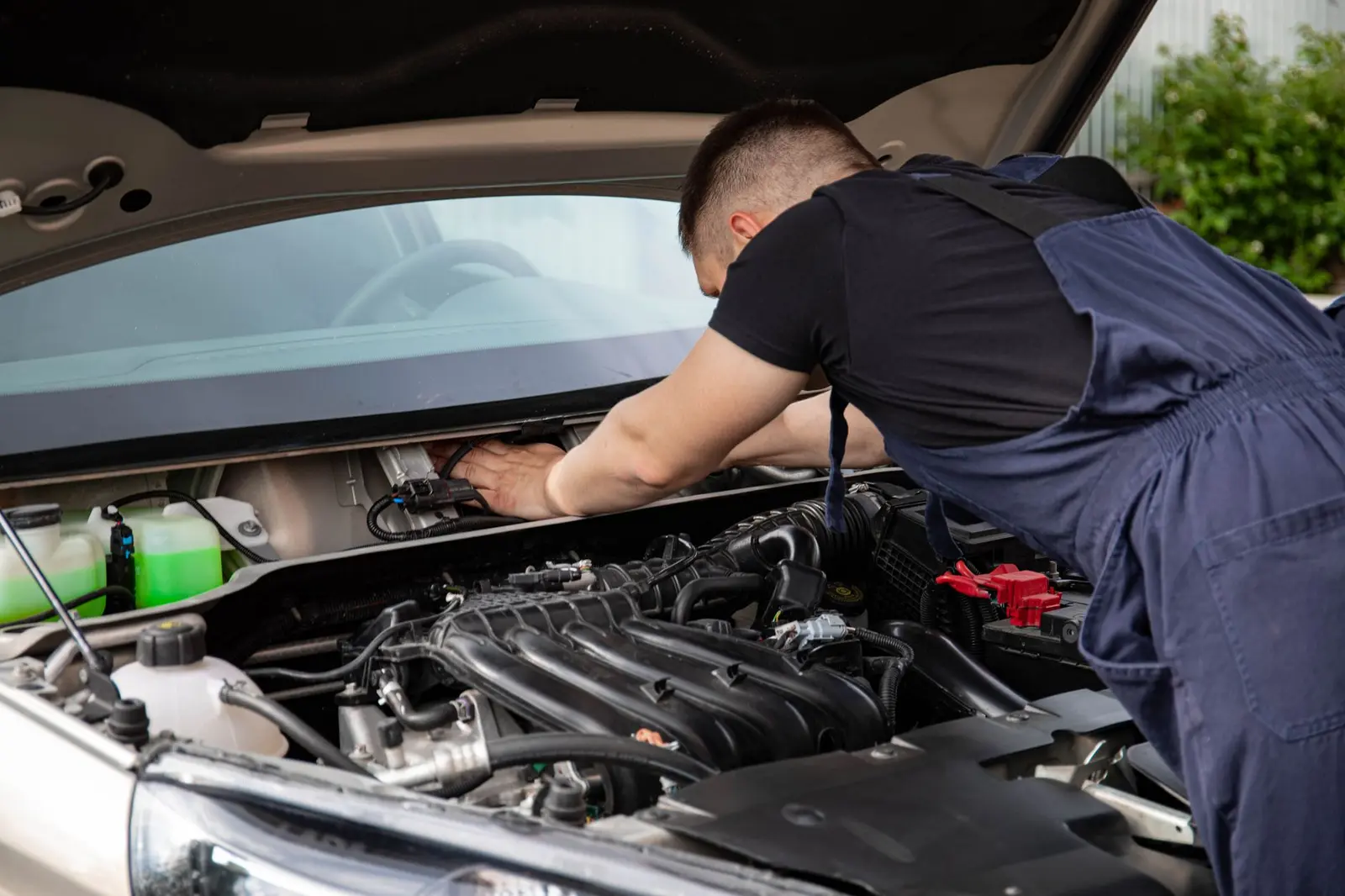 Mechanic working on a car engine — a West Midlands trades business we support
